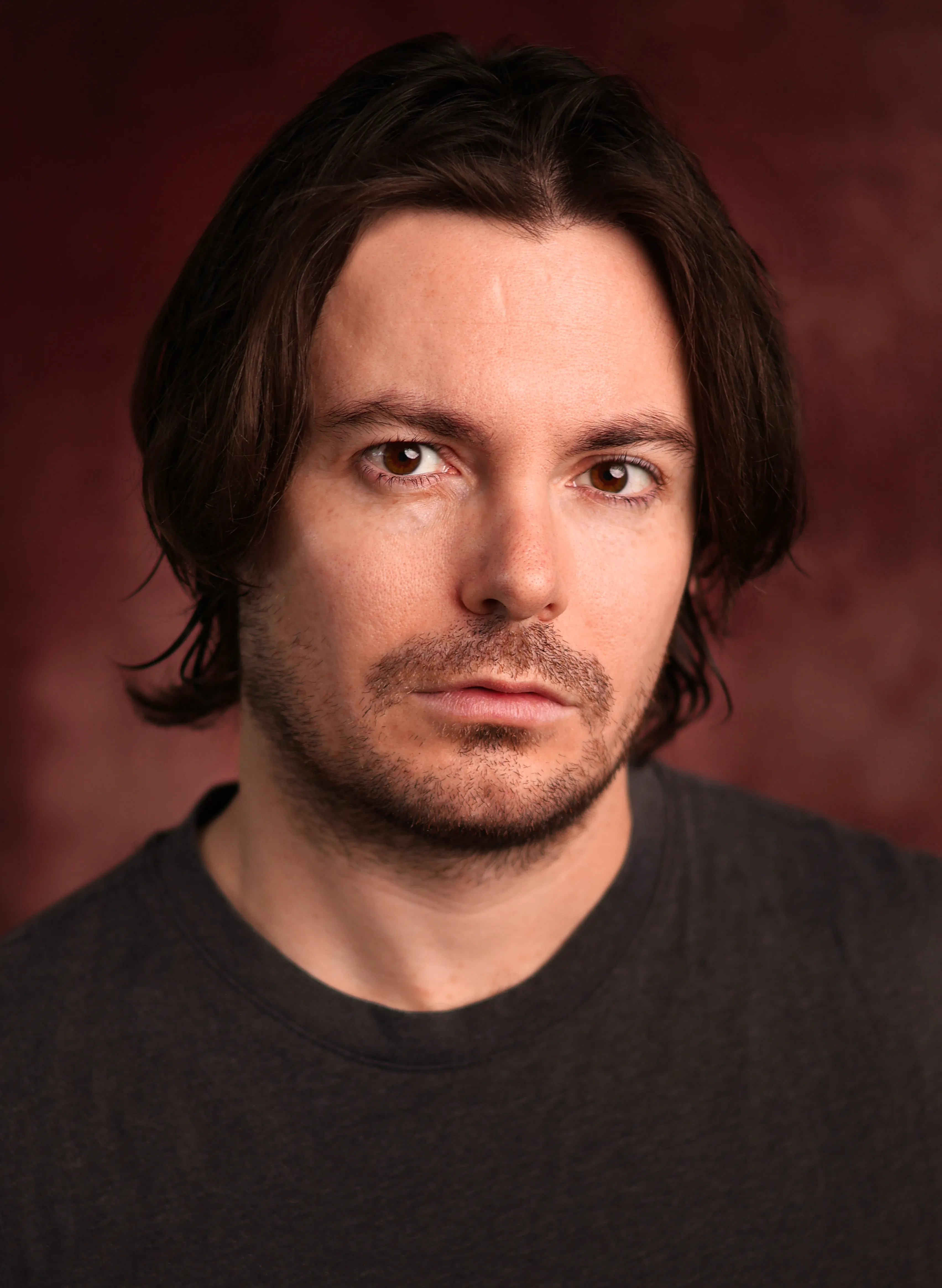 Luke Hunter in a black shirt, looking directly at the camera